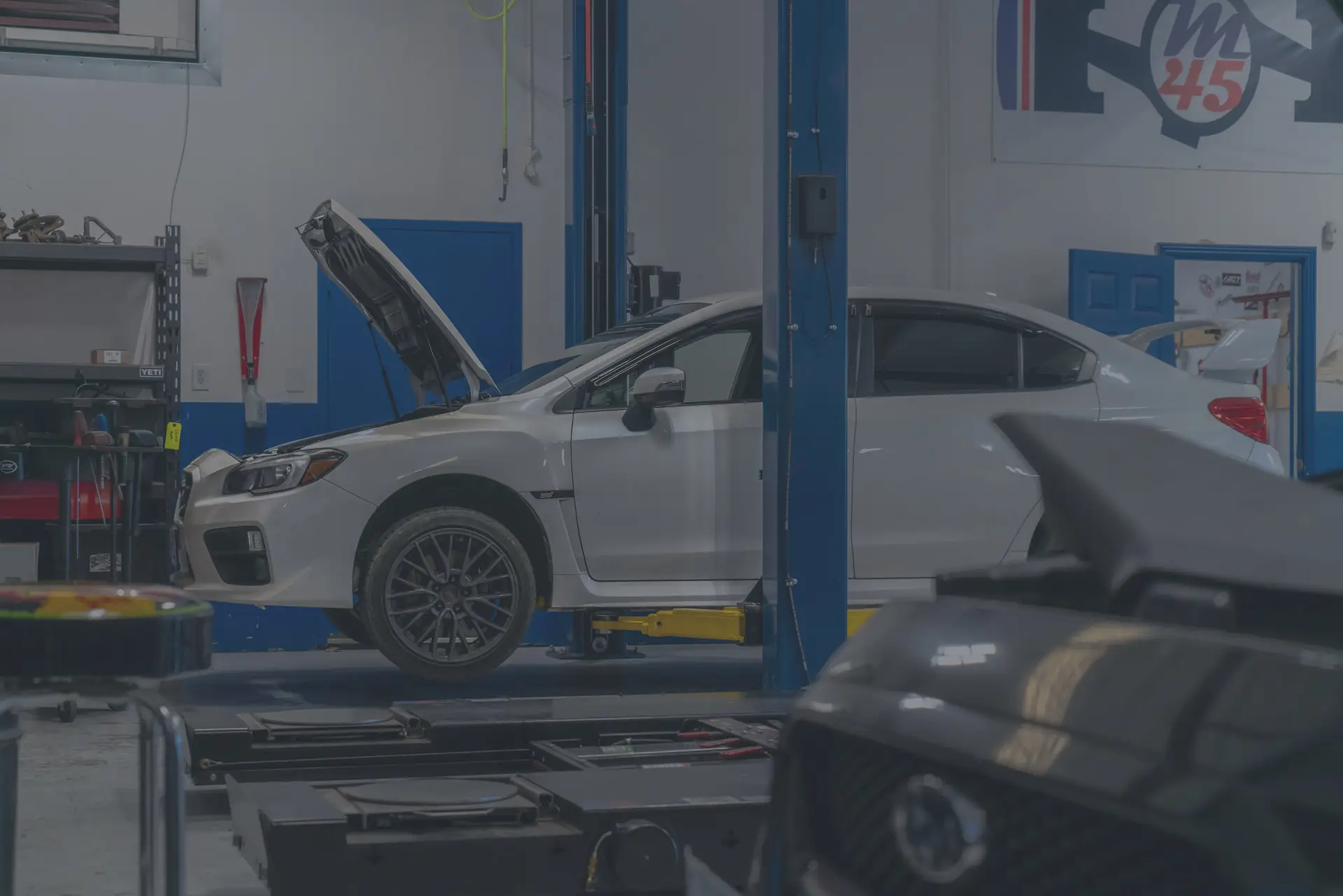 M45 Automotive shop floor — Subaru WRX on the lift in Auburn, CA